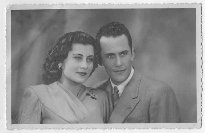 Black and white photo of young couple standing next to each other.