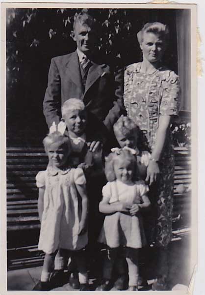 Black and white photo of couple with four kids.