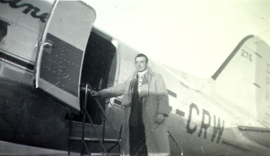 Giovanni in an overcoat boarding a plane.