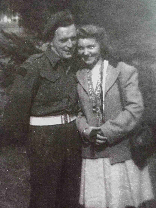 Old grainy photograph of a bride and groom on their wedding day.