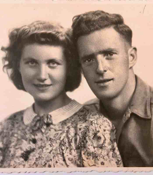 A man and woman pose for a portrait photo.