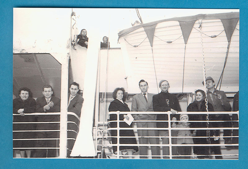 Several people on deck of ship, Seven Seas.