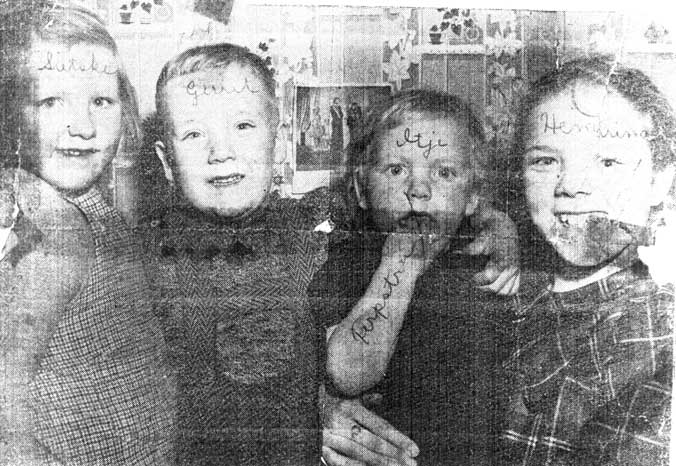 Archival image of four children with their names written on the photo.