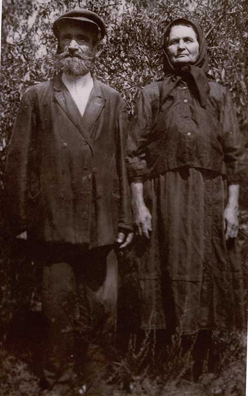 Archival image of unsmiling couple dressed in black.