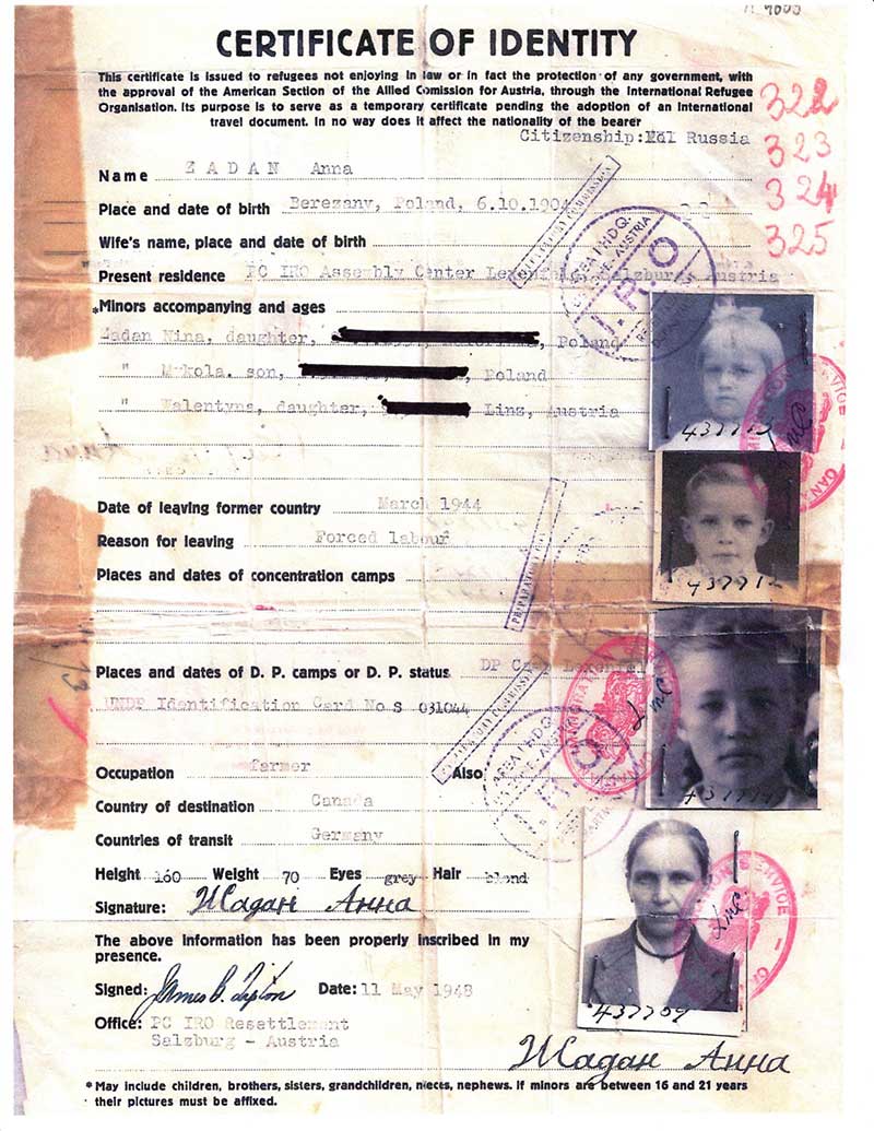 Old document titled Certificate of Identity, with photos stapled on.