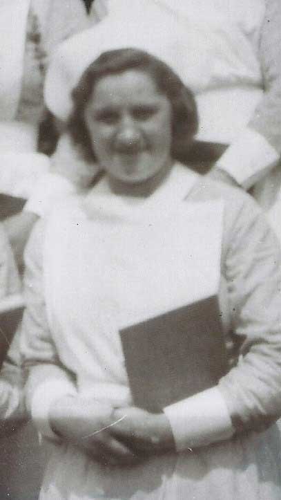 A young woman in a nurse's uniform holds a book in her hand.
