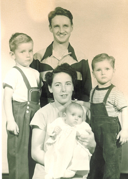 Portrait of a young man and a woman with three children. 