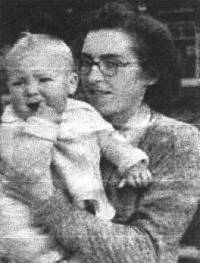 Older photograph of woman wearing glasses and holding small boy.