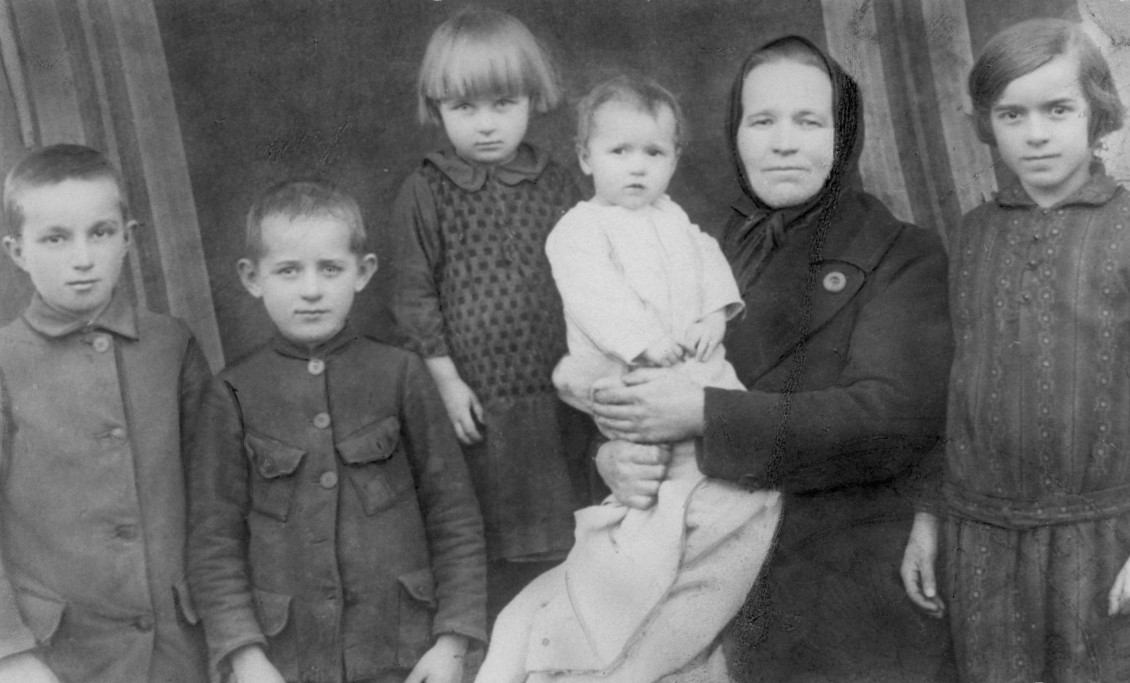 Archival passport photo of a woman and five children.