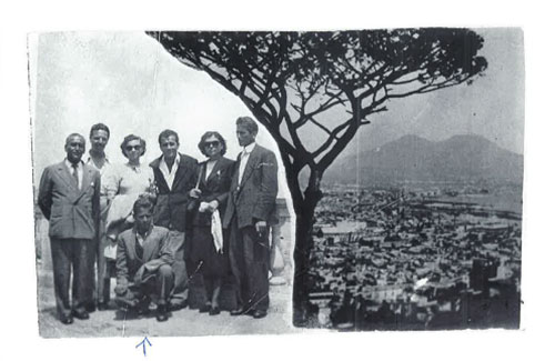 A group pf people on left side of photo and view of a hilltop on the right.