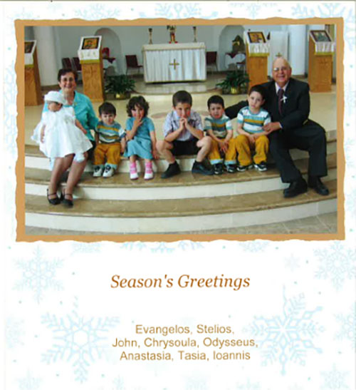 A family Christmas card with parents and six children. They are sitting in a building of worship.