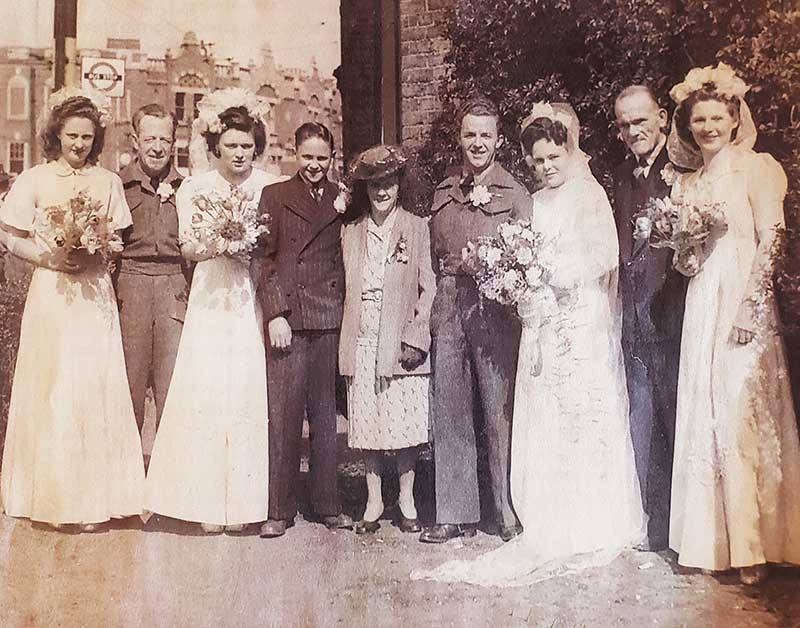 Sepia photograph showing several members of a bridal entourage on a wedding day.