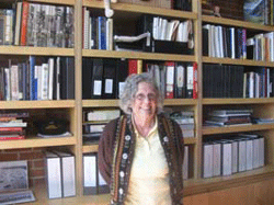 Woman standing in front of library bookshelf.