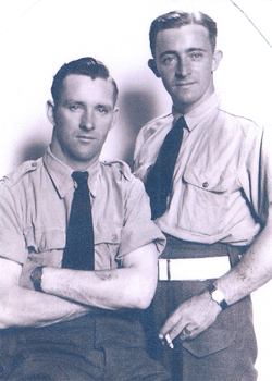 Man in uniform seated, with Cecil standing next to him holding cigarette.