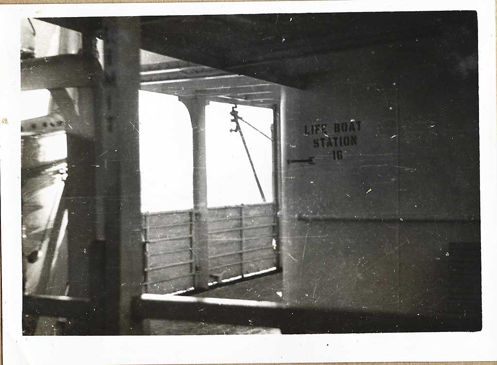 Black and white photo of a ship’s deck with Life Boat Station 10 written on the wall.
