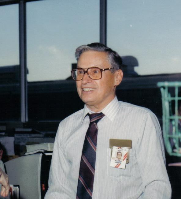 Middle-aged man with glasses and name tag.