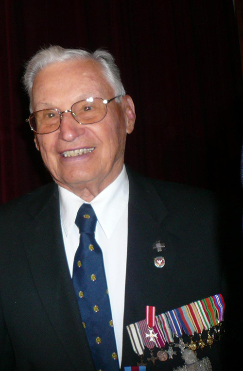 Older veteran with military decorations.
