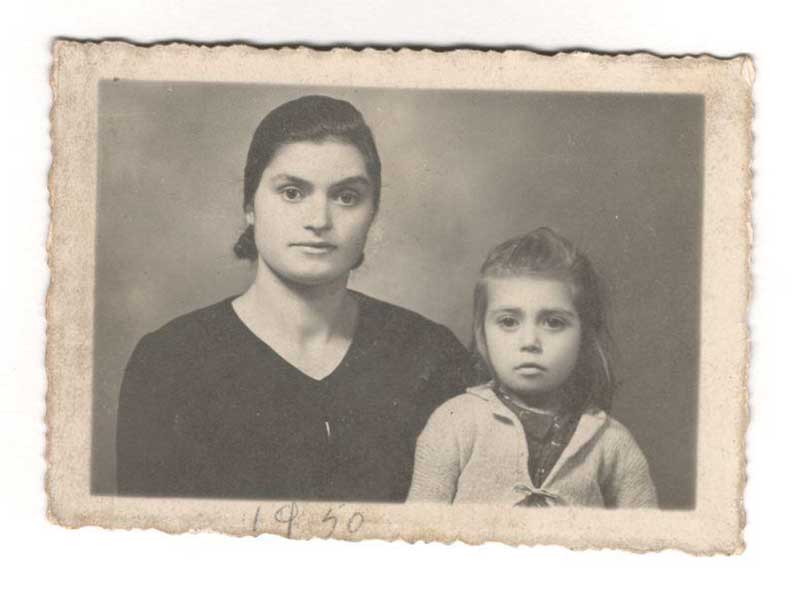Archival photograph of a woman and her daughter, dated 1950.