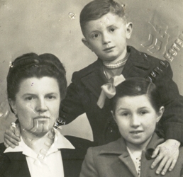 Passport photo of woman and two children, with stamp markings on it.