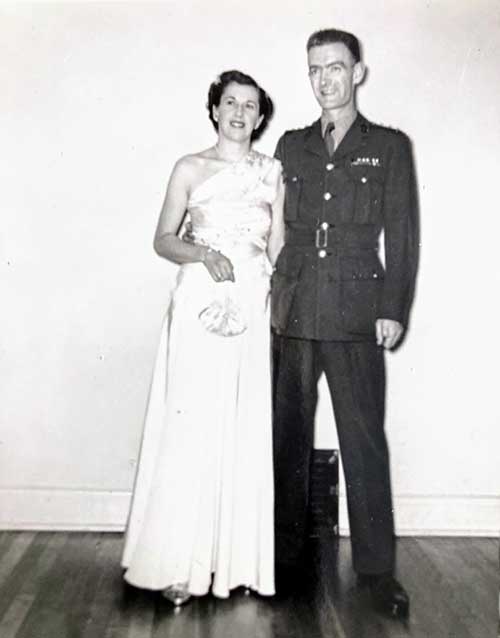 Young man and woman pose for a photograph.