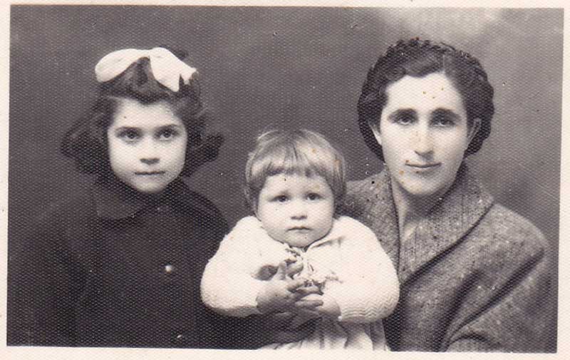 Black and white photo of young lady with two small children.