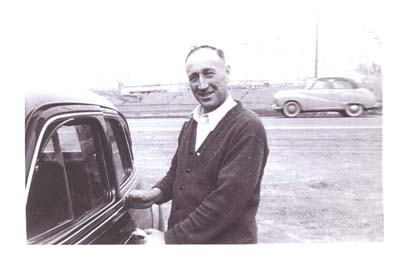 Young George standing next to a car.