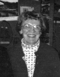 Mary as an older woman, wearing glasses.