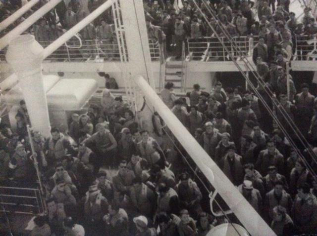 Large group of people on board a ship.