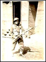 Bernard as a young soldier, wearing a helmet and his gun.