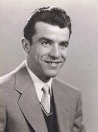 Portrait of smiling Nicola, in suit and tie.