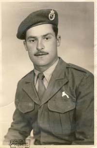 The young Nikolas in uniform, a beret on his head and wearing a mustache.