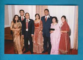 Coloured photo of members of Om family in formal dress.