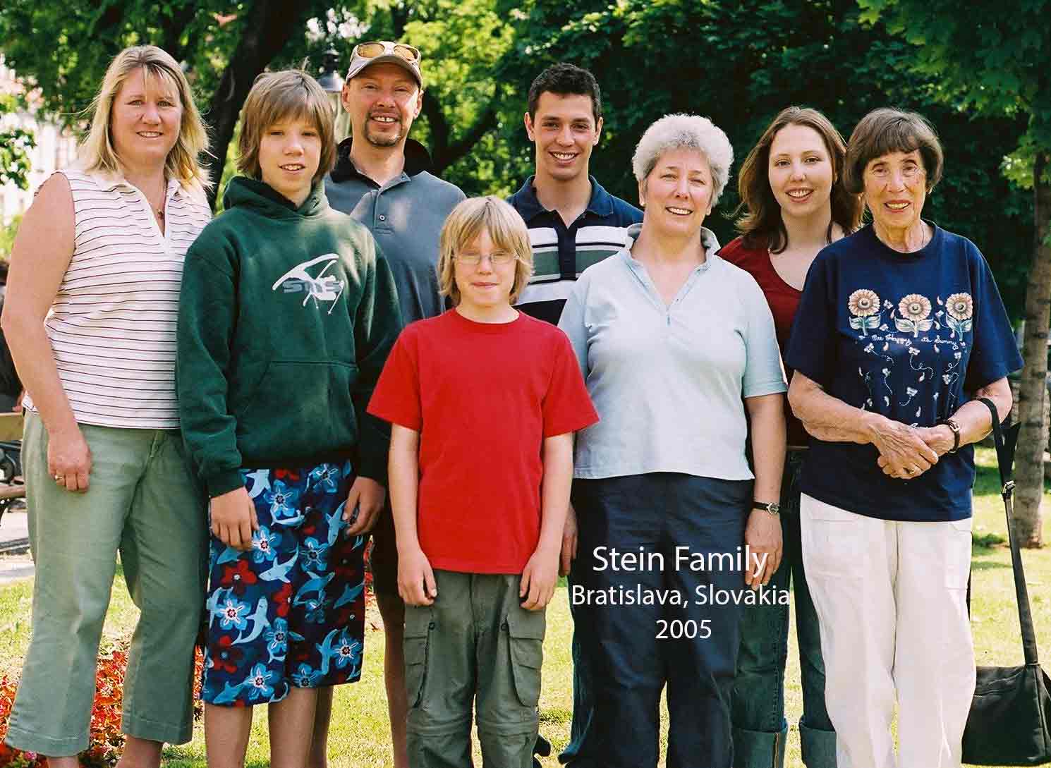 A Slovakian family, including adults and children, standing outside and smiling for the camera.