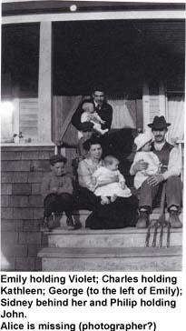 Family with babies sitting on steps of front porch.