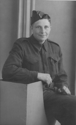 Army photograph of young Norman, sitting and wearing the uniform. 