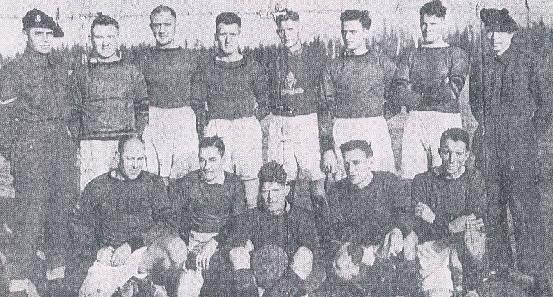 A group of men in athletic clothing pose for the camera.