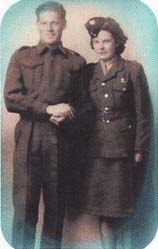 Portrait of young man and woman standing in military uniforms.