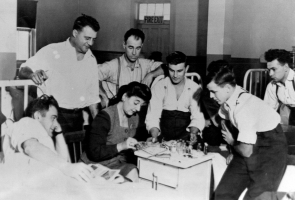 Sadie with men in a hospital room at Camp Hill.