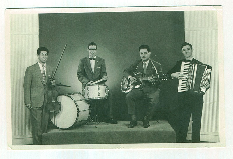 A professional photograph of a musical quartet band.
