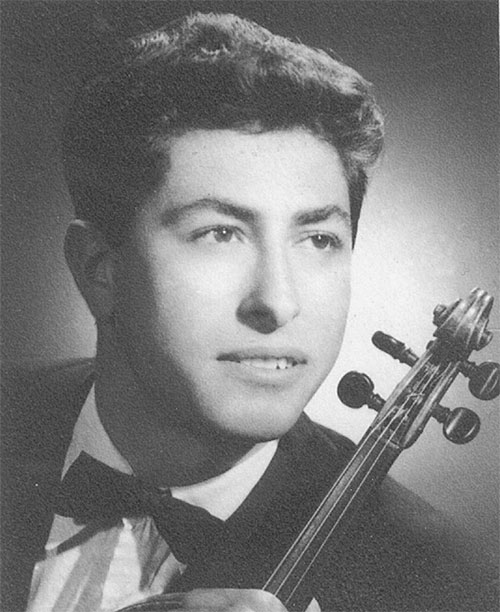 A facial portrait of a young man, the neck of a violin can be seen next to him.