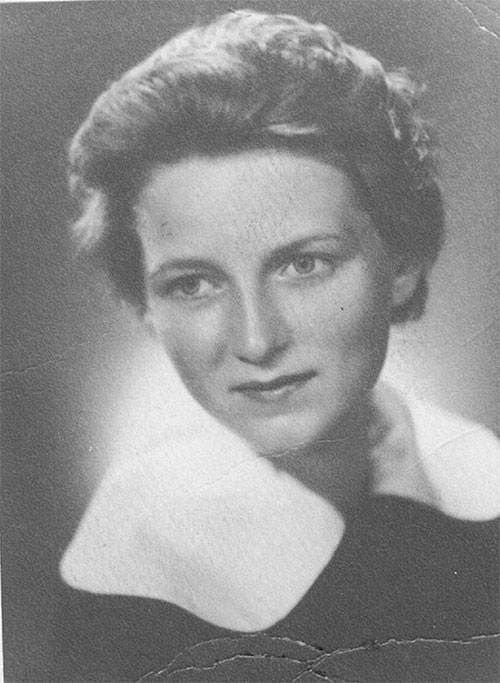 A facial portrait of a young woman with short hair, she is wearing a top with a big white collar.