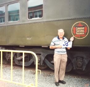 Siegfried, elderly man, standing in front of a train car.