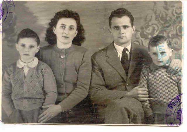 Old passport photo of man, woman and two children.