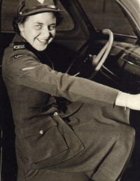 Young Catherine in military uniform, sitting at the wheel of an army jeep.