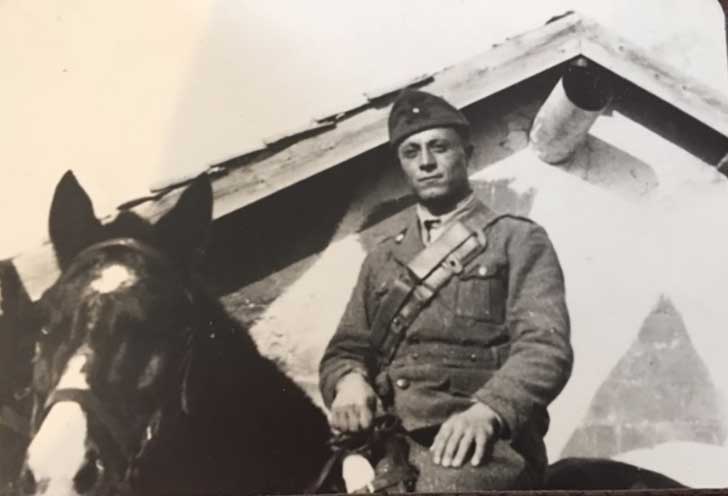 Archival photo of a soldier sitting on a horse.