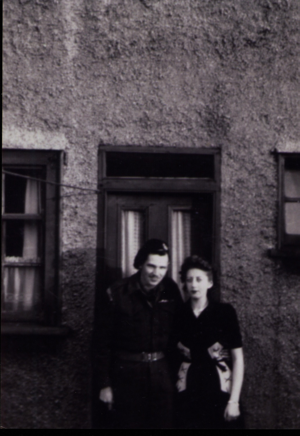 Man and woman standing in front of building.