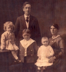 A sepia portrait of a mother, a father and three grandchildren.