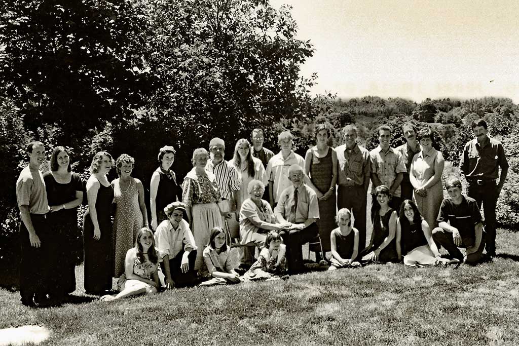 A modern black and white portrait of a large family.