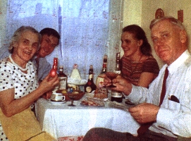 Colour photograph showing four family members sitting at the kitchen table.