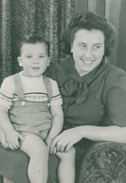 Young Joyce seated in armchair with baby son in her lap.